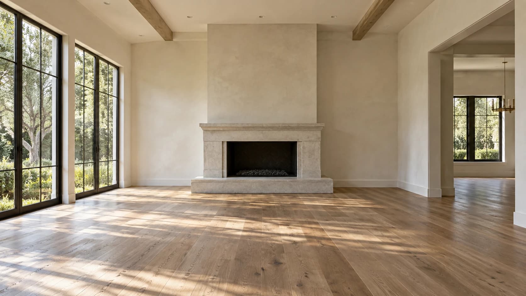 The same illustrative living room before staging, with wood floors, large windows and a stone fireplace